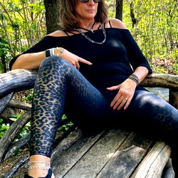 Chic Woman in Leather Outfit Posing on a Bench