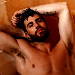 Muscular Man Relaxing in Bathtub